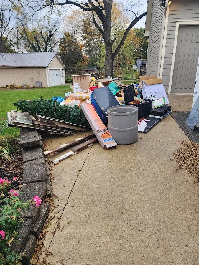 Dumpster being loaded with debris for 3 Yard Dumpster Rental in Maple Valley
